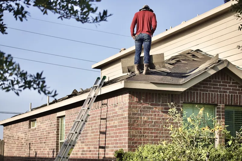 Professional roofer working on a residential roof in Clackamas Heights